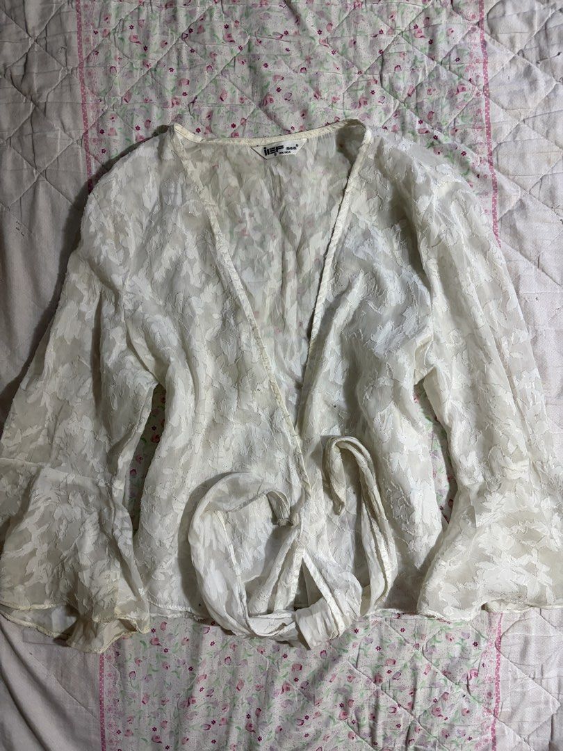 White Lace Wrap Top (Category: Longsleeves) located in Muntinlupa City. Submitted by herellas0504 (Listing ID 1461364214, Image 1). Description: White Lace Wrap Top Mine: 150 | Lock: 200 xs-med has small stains (need wash).