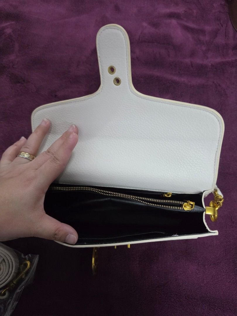 White Leather Clutch Bag with Gold Hardware (Category: Clutches) located in Manila. Submitted by f3v1nadump (Listing ID 1461377000, Image 3). Description: - Chic white leather clutch bag - Secure gold-tone clasp closure - Includes a detachable strap for versatility - Features an interior zippered pocket for essentials - Classic and clean design, ideal for evening wear or special occasions.