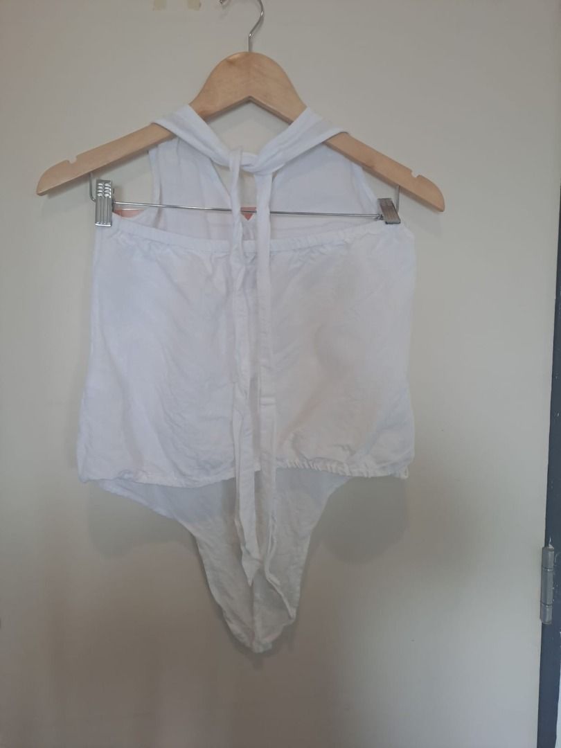 white linen halter (Category: Sleeveless) located in Mandaluyong City. Submitted by epicowl-c93c (Listing ID 1461427687, Image 2). Description: The image shows a white cotton linen halter top styled with a drawstring or elastic back closure and a tied neck finish. This lightweight, open-back silhouette features a loose, pointed asymmetrical front hemline making it a great piece for beach vacations or summer street styling..