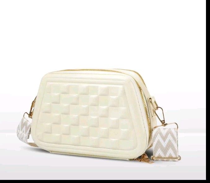 White Quilted Crossbody Bag with Zigzag Strap (Category: Cross-body Bags) located in Manila. Submitted by swshop.705 (Listing ID 1461442468, Image 1). Description: Take these 2 for 350 only. - Cute white crossbody bag - Stylish quilted pattern on the front - Detachable zigzag strap for versatile styling - Elegant gold zipper details - Ideal for everyday use or evening outings - Spacious enough for your phone, wallet, and keys - Lightweight and ea