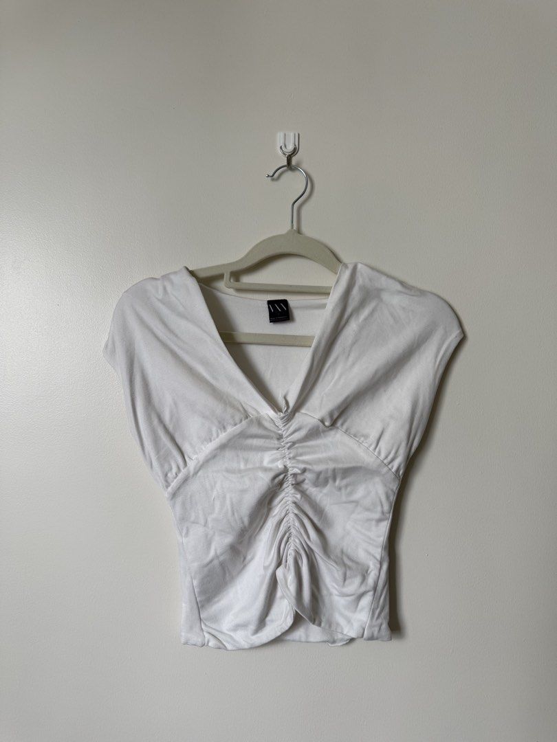 White Ruched V-Neck Top (Category: Blouses) located in Pasig City. Submitted by yensyard__ (Listing ID 1461381551, Image 1). Description: - xs-s frame - White short-sleeved top - Deep V-neckline - Ruching detail down the front for a flattering fit - Simple and versatile wardrobe staple.
