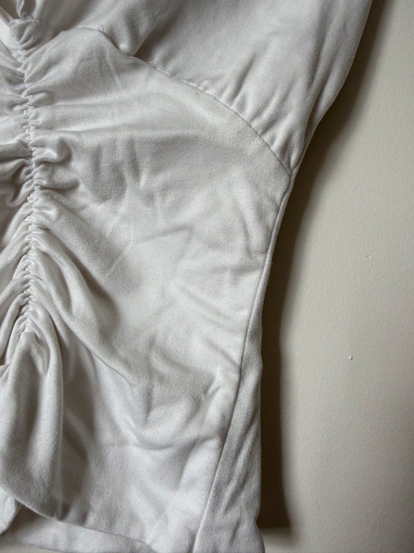 White Ruched V-Neck Top (Category: Blouses) located in Pasig City. Submitted by yensyard__ (Listing ID 1461381551, Image 3). Description: - xs-s frame - White short-sleeved top - Deep V-neckline - Ruching detail down the front for a flattering fit - Simple and versatile wardrobe staple.