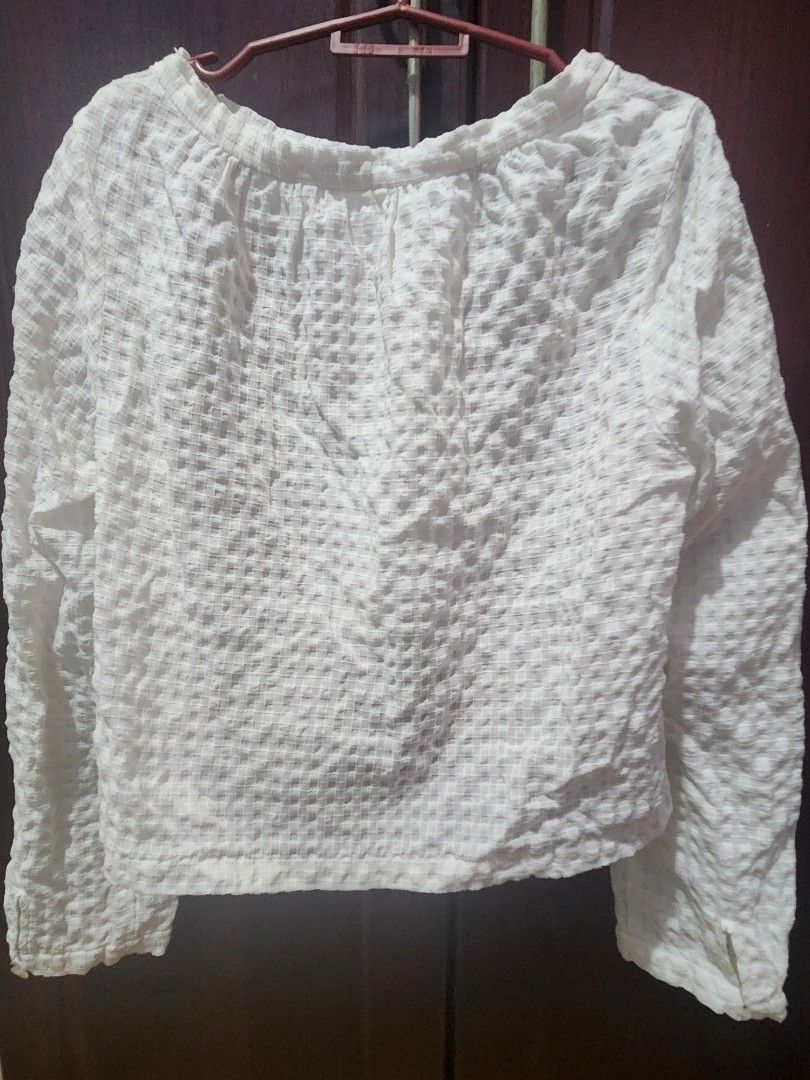 White Textured Puff Sleeve Top (Category: Blouses) located in Muntinlupa City. Submitted by yanyan1888 (Listing ID 1461372543, Image 3). Description: - Chic white top with a unique textured, crinkled fabric. - Features stylish puff sleeves for a feminine touch. - Elegant round neckline adorned with small button details. - Tag indicates size small, ideal for a petite fit. - Versatile piece, perfect for elevating your everyday casual wear..