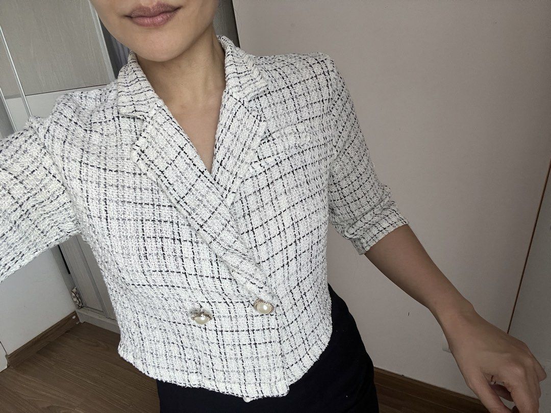 White Tweed Cropped Double-Breasted Blazer (Category: Coats, Jackets and Outerwear) located in Makati City. Submitted by warm.abc123 (Listing ID 1461405850, Image 2). Description: - White tweed cropped blazer - Black and silver thread details - Double-breasted front - Pearl button closure - Cropped length (hits at waist) - Three-quarter sleeves - Chic and sophisticated style - Versatile for dressing up or down.