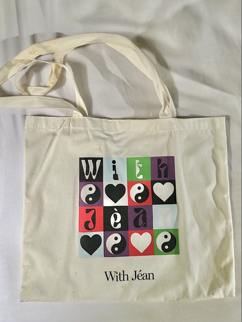With Jean Tote Bag (Category: Tote Bags) located in Manila. Submitted by internetdreamgirl888 (Listing ID 1461422659, Image 1). Description: With Jéan Graphic Canvas Tote Bag ✔️ Authentic With Jéan tote ✔️ Large canvas tote bag ✔️ Features colorful graphic print with hearts and yin-yang motifs ✔️ Spacious enough for daily essentials, books, groceries, or errands ✔️ Long shoulder straps ✔️ Lightweight and reusable May request for more photos..
