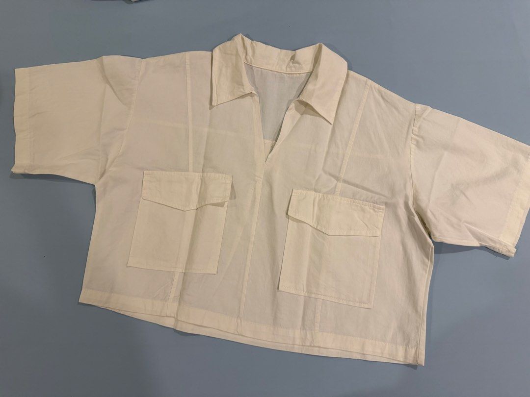 Womens Cropped Boxy Polo (Category: Shirts) located in Imus. Submitted by yummyfinds (Listing ID 1461486844, Image 1). Description: - Cream colored cropped shirt - Collared neckline - Two front pockets - Short sleeves - Breathable cotton blend fabric - Ideal for casual wear or layering - Simple and versatile design.
