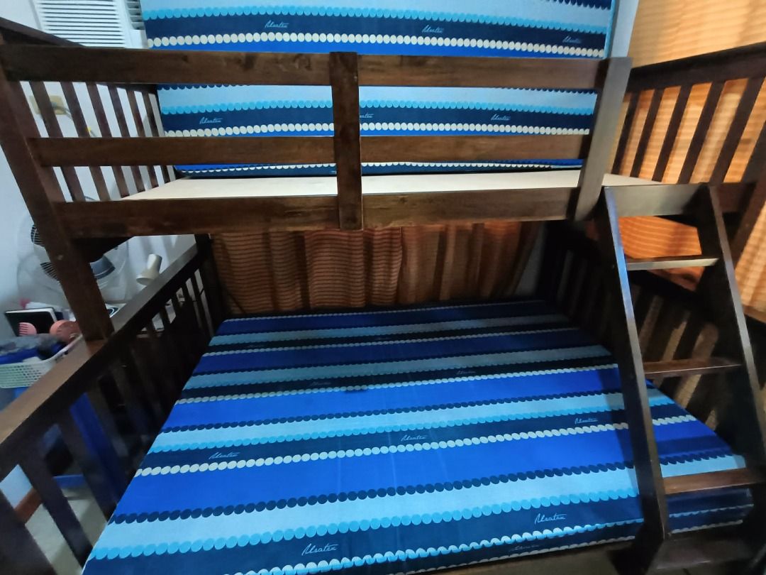 Wooden Bunk Bed with Mattresses (Category: Bed Frames & Mattresses) located in Carmona. Submitted by estelle01 (Listing ID 1461420995, Image 2). Description: - Solid wood bunk bed from SanYang (top single, bottom queen) - Dark brown finish - Includes two mattresses (Uratex brand) - Ladder attached on the right side - Sturdy construction - reinforced base and added plywood For Pick-up: Faith Street Cityland Subd., Carmona, Cavite PH 4116.