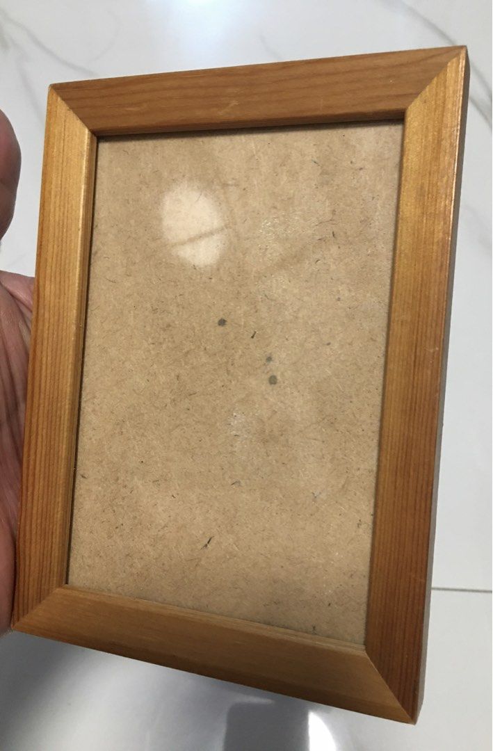 Wooden Photo Frame for Tabletop Display (Category: Frames & Pictures) located in Pasay City. Submitted by gilbertso62551 (Listing ID 1461437774, Image 2). Description: - Simple wooden photo frame - Natural wood finish - Built-in easel for standing display - Fits standard photo size - Ideal for desks and shelves - Minor marks on backing board (front is clear) - Ready for your favorite photo! - As is l,where is - Frame only - Needs cleaning .