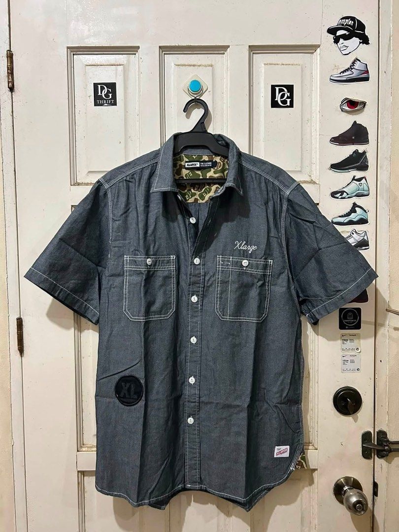 XLarge Denim Short Sleeve Button Up Shirt (Category: Tshirts & Polo Shirts ) located in Pasay City. Submitted by deguzmanjay (Listing ID 1461518227, Image 1). Description: - XLarge short sleeve denim shirt - White contrast stitching - Two chest pockets - Camo print lining inside - Embroidered XLarge logo on chest - XL patch on left side - Small XLarge tag on bottom hem - Button-up front.