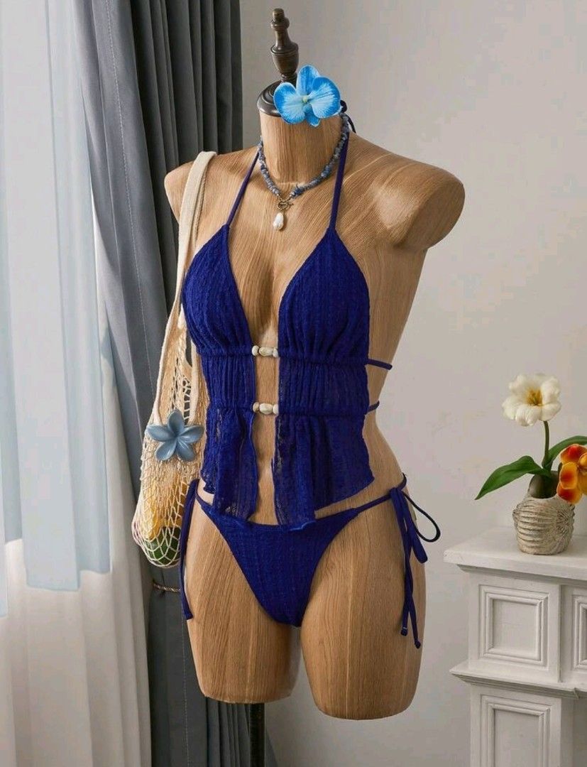 XS Blue Halter Neck Bikini Set (Category: Bikinis & Swimsuits) located in Makati City. Submitted by _gemelli (Listing ID 1461500829, Image 3). Description: - XS Navy Blue Halter Neck Tankini Top With Tie Back And Plain Bikini Bottom Swimwear Set - Halter neck top with tie-back closure - Used once - Ruffled peplum detail on top with decorative buttons - Comfortable and stylish design.