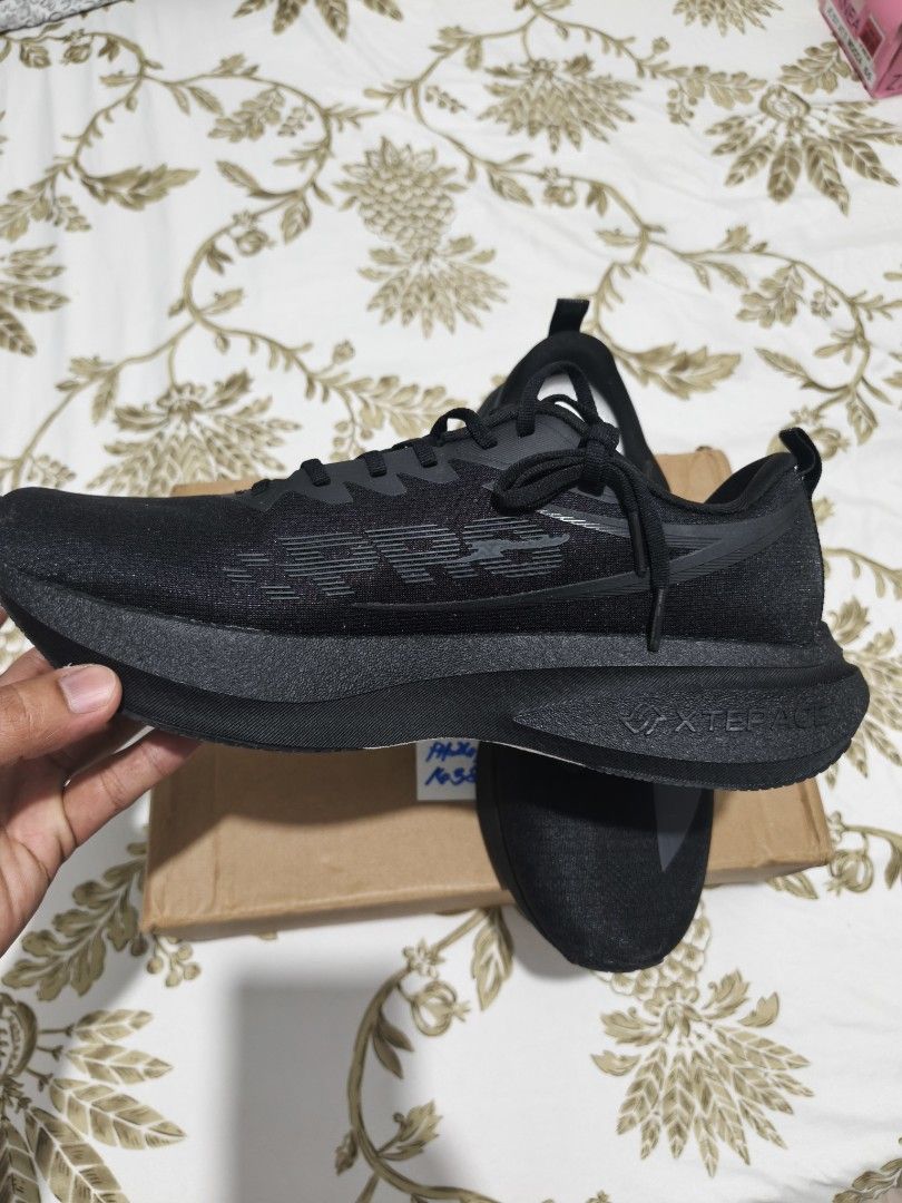 Xtep Black Running Shoes (Category: Sneakers) located in Taguig. Submitted by akyliscloset (Listing ID 1461351230, Image 3). Description: - Brand: Xtep - Color: Black - Material: Lightweight and breathable mesh upper - Sole: Thick, cushioned for maximum comfort - Closure: Lace-up - Ideal for: Running, gym, or everyday wear - Condition: Brand new with original tags.