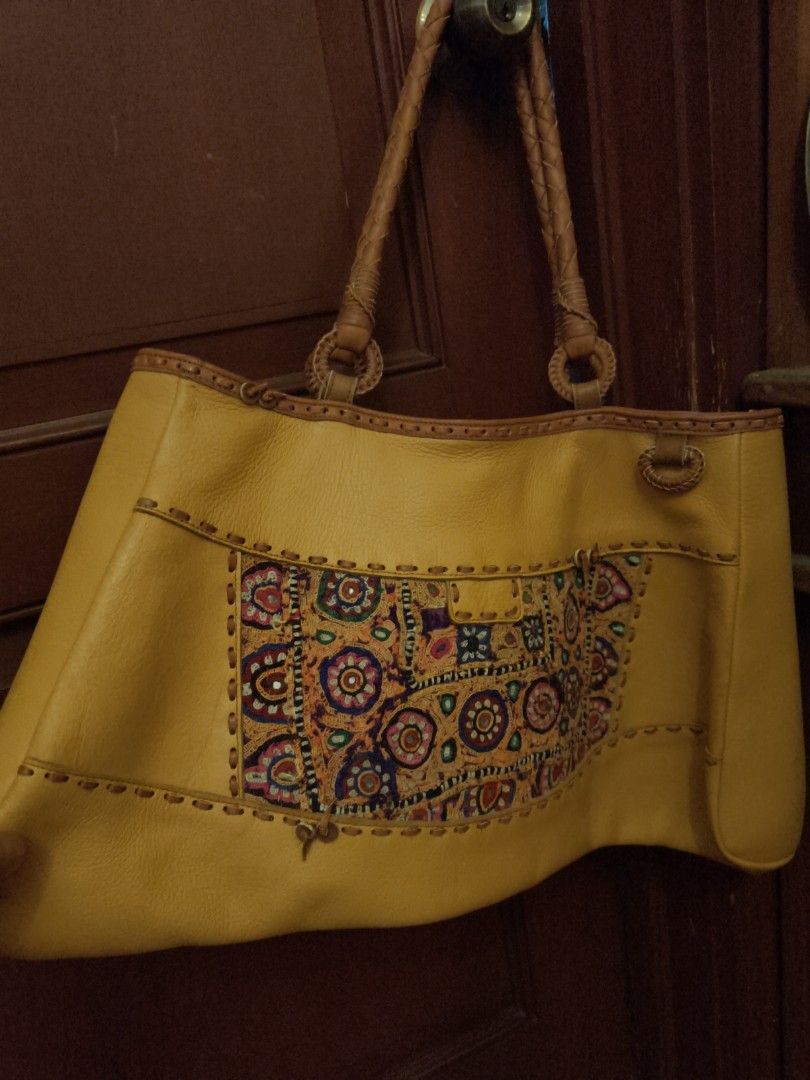 Yellow Leather Tote Bag with Embroidered Patch (Category: Tote Bags) located in Quezon City. Submitted by trace.abella (Listing ID 1461437881, Image 2). Description: - Vibrant yellow leather tote bag - Eye-catching colorful embroidered patch on the front - Stylish braided leather handles - Secure zipper closure at the top - Interior features one zippered pocket and two slip pockets - Ideal for everyday use and errands.