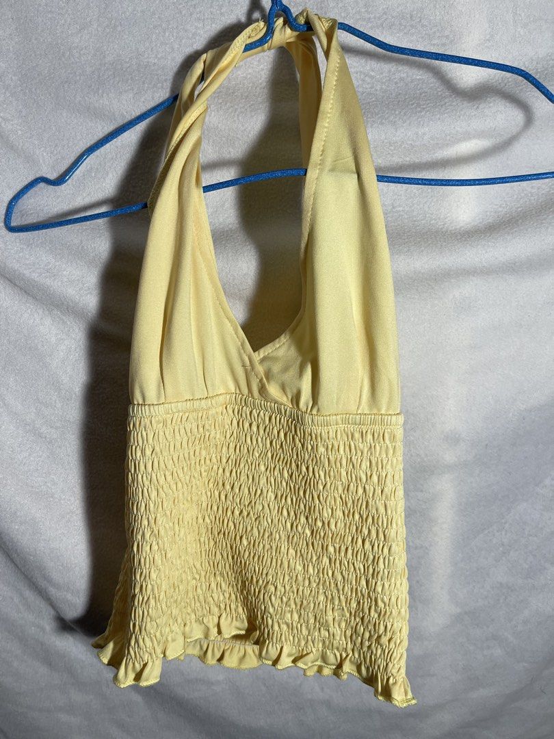 Yellow Smocked Halter Top with Ruffle Hem (Category: Sleeveless) located in Bulacan. Submitted by rvnczlle (Listing ID 1461344245, Image 1). Description: - Adorable yellow halter top - Smocked bodice for a stretchy, comfortable fit - Cute ruffle detail at the hem - Ties at the neck - Ideal for hot weather - Versatile: pairs easily with shorts or skirts.