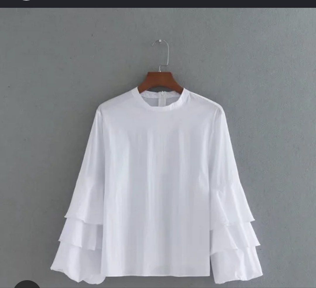 Zara Basic White Ruffle Sleeve Mock Neck Blouse XS (Category: Blouses) located in Quezon City. Submitted by thyca (Listing ID 1461482607, Image 1). Description: - Zara Basic white long sleeve blouse - Mock neck with back zip closure - Features stylish tiered ruffle sleeves - Perfect for dressing up or down - Comfortable and chic - RFS: Declutterring - Price negotiable .