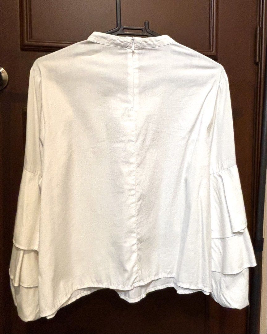 Zara Basic White Ruffle Sleeve Mock Neck Blouse XS (Category: Blouses) located in Quezon City. Submitted by thyca (Listing ID 1461482607, Image 2). Description: - Zara Basic white long sleeve blouse - Mock neck with back zip closure - Features stylish tiered ruffle sleeves - Perfect for dressing up or down - Comfortable and chic - RFS: Declutterring - Price negotiable .
