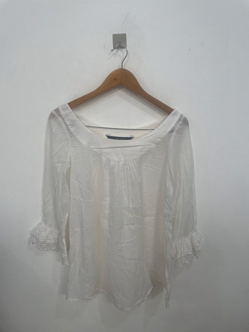 Zara Basic White Sheer Blouse with Lace Detail (Category: Blouses) located in Las Pinas. Submitted by qcleopatrastrove (Listing ID 1461336058, Image 1). Description: *Sheer fabric with delicate lace details on the sleeves *Three-quarter length sleeves *Gathered detailVersatile for casual or dressy occasions *XS on tag but can fit small to medium frames for loose wear *With stain due to usage (Check the third photo.) *Yellow color is due to lighti