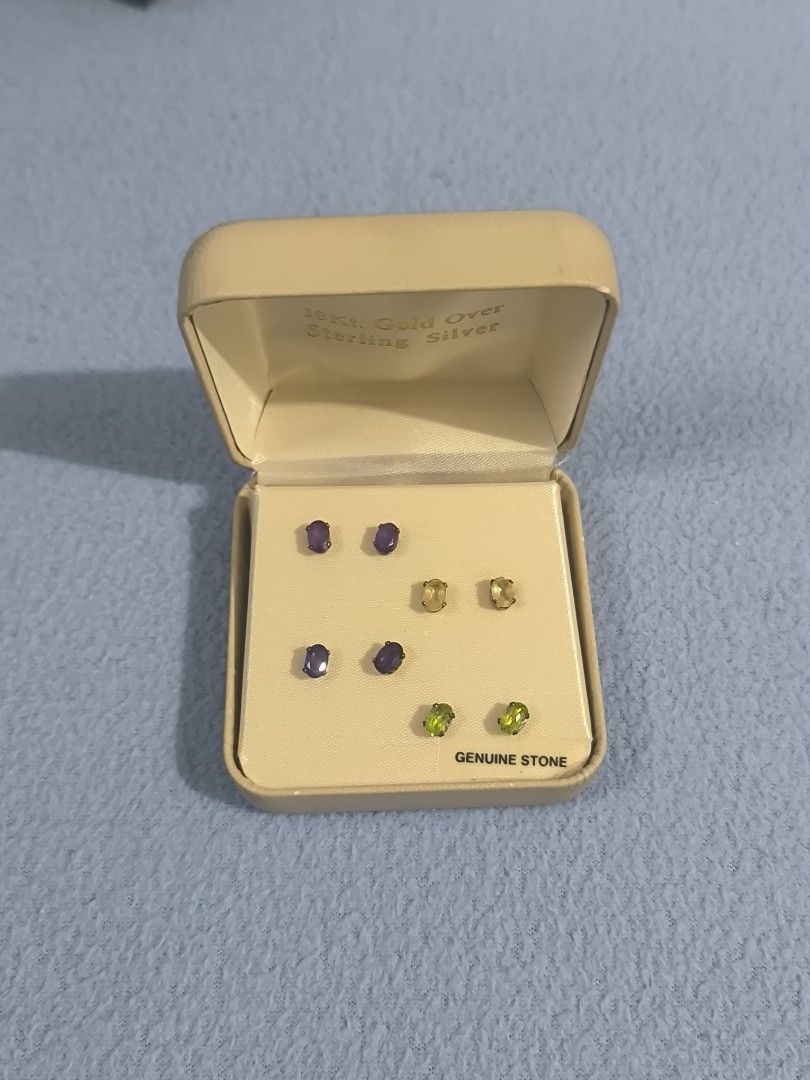 18kt Gold Over Sterling Silver Gemstone Stud Earrings Set (Category: Earrings) located in General Santos City (Dadiangas). Submitted by animoya (Listing ID 1461645026, Image 1). Description: - Set of 6 pairs of genuine gemstone stud earrings - Features purple, yellow, and green stones - Crafted with 18kt gold over sterling silver - Ideal for mixing and matching your style.