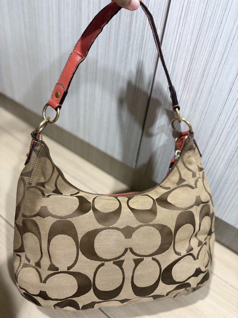 🧡 Coach Signature Stripe Hobo (Category: Beach Bags) located in Lingayen. Submitted by jhaneshop (Listing ID 1461740101, Image 3). Description: 🧡 Coach Signature Stripe Hobo 𐙚 ̊ Style No.: F19281 𐙚 ̊ Produced: 2012 𐙚 ̊ Model/Style: Signature Stripe Hobo 𐙚 ̊ Colorway: Khaki/Coral 𐙚 ̊ Signature fabric with patent trim 𐙚 ̊ Includes Coach hangtag 📝 Condition: Signs of use and cracking along the handle/strap edges. Inner lining has visible di