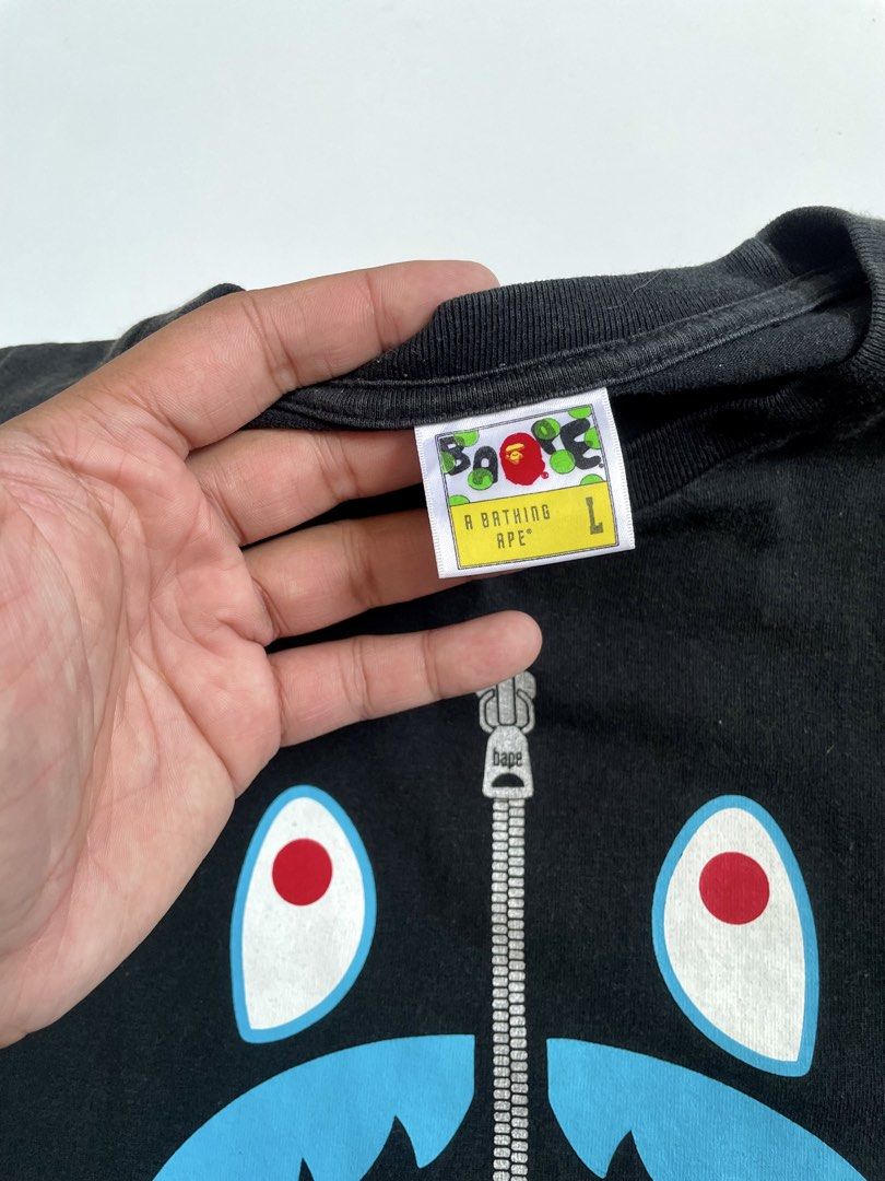 A Bathing Ape Shark Head Shirt (Category: Tshirts & Polo Shirts ) located in Imus. Submitted by streetgrails.ph (Listing ID 1461612913, Image 3). Description: BAPESHARK ZIP TEE 22 x 27 ( size large on tag ) in excellent condition 9/10 color rate no issue! imus cavite loc! 📍 courier/mode of delivery: j&t or lalamove mode of payment: payment first thru gcash only! 📌 no return/refund! 📌 can send proof of legitimacy! .