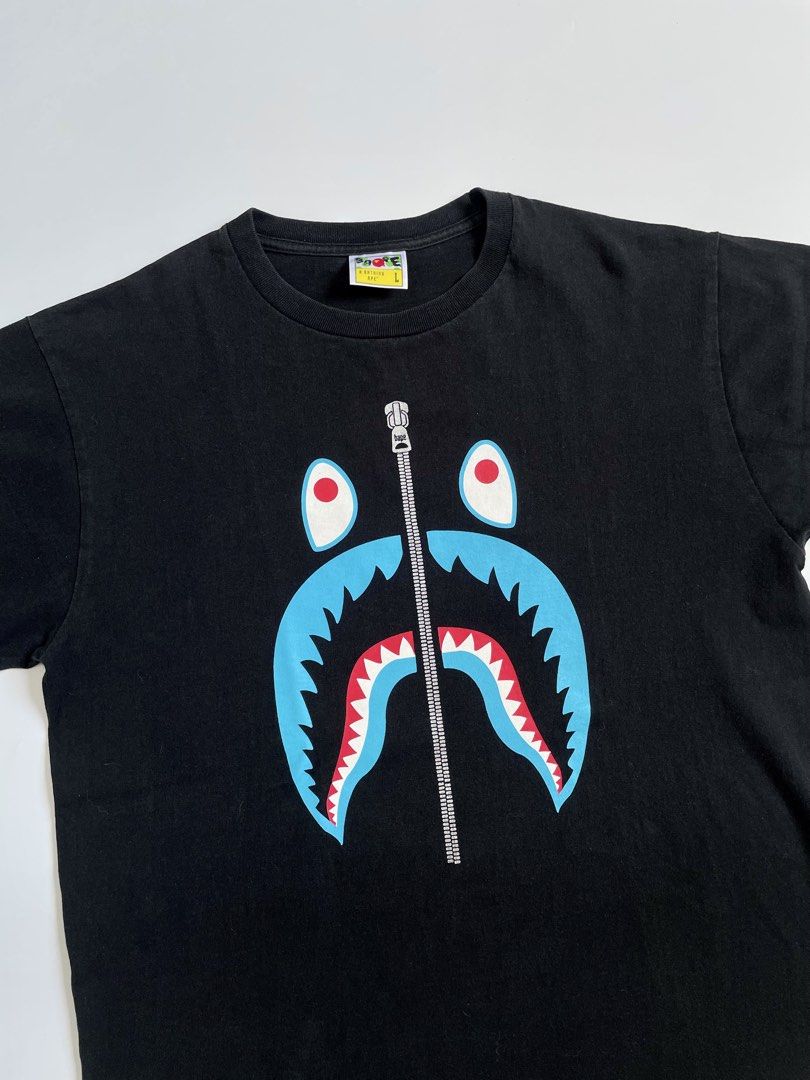 A Bathing Ape Shark Head Shirt (Category: Tshirts & Polo Shirts ) located in Imus. Submitted by streetgrails.ph (Listing ID 1461612913, Image 2). Description: BAPESHARK ZIP TEE 22 x 27 ( size large on tag ) in excellent condition 9/10 color rate no issue! imus cavite loc! 📍 courier/mode of delivery: j&t or lalamove mode of payment: payment first thru gcash only! 📌 no return/refund! 📌 can send proof of legitimacy! .