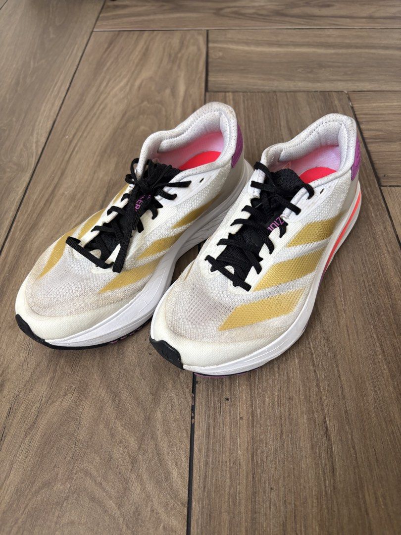 Adidas Adizero SL2 (Category: Sneakers) located in Paranaque City. Submitted by gabbyrela (Listing ID 1461568276, Image 3). Description: - Adidas SL2 - Color: White with gold stripes and purple accents - Size: 6 US Men/7.5 US Women .
