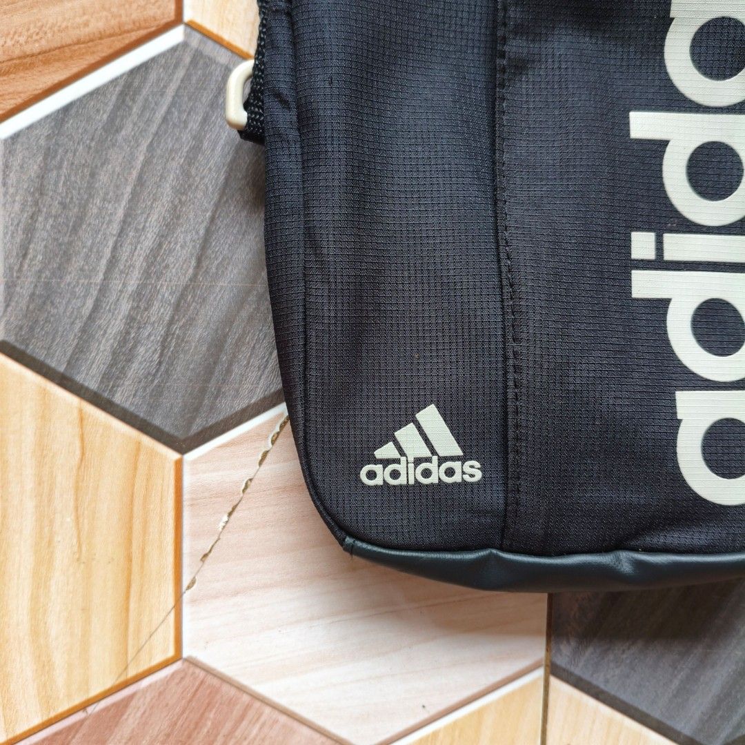 Adidas Black Crossbody Sling Bag (Category: Sling Bags) located in Manila. Submitted by caps08 (Listing ID 1461594821, Image 3). Description: - Black Adidas sling bag - Features Adidas logo on front and side - Adjustable strap for comfortable wear - Zippered pocket for secure storage - Ideal for carrying daily essentials - Great for everyday use.