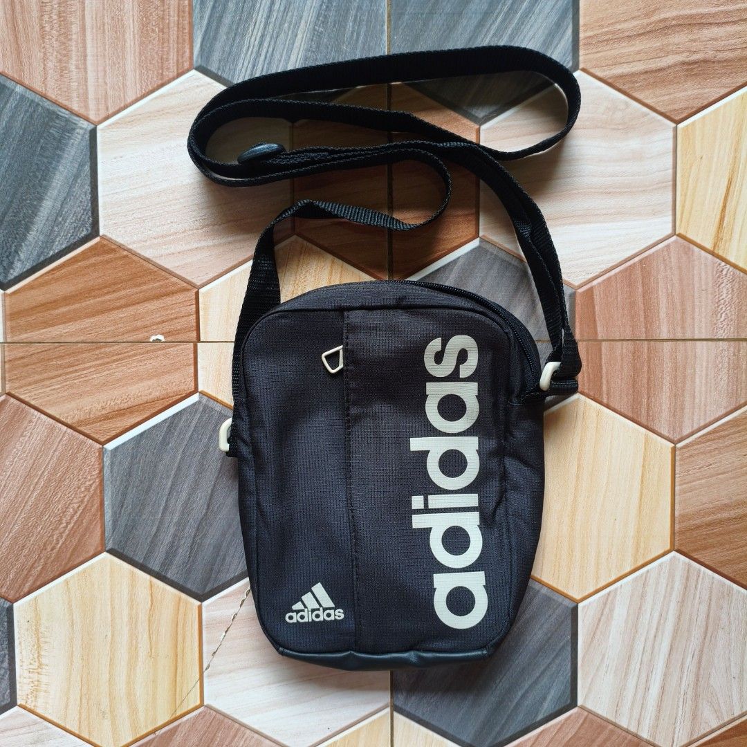 Adidas Black Crossbody Sling Bag (Category: Sling Bags) located in Manila. Submitted by caps08 (Listing ID 1461594821, Image 1). Description: - Black Adidas sling bag - Features Adidas logo on front and side - Adjustable strap for comfortable wear - Zippered pocket for secure storage - Ideal for carrying daily essentials - Great for everyday use.
