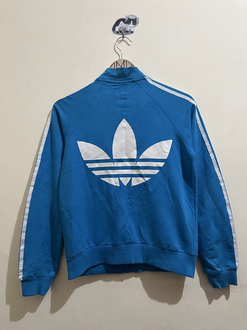 Adidas Blue Track Jacket with Trefoil Logo (Category: Coats, Jackets and Outerwear) located in Manila. Submitted by juspheroca82034 (Listing ID 1461683483, Image 2). Description: - Classic blue Adidas track jacket - Iconic trefoil logo on back and chest - White stripes on sleeves - Zip-up front with pockets - Ribbed cuffs and hem - Ideal for casual wear or sports -for kids 8-10 yrs old.