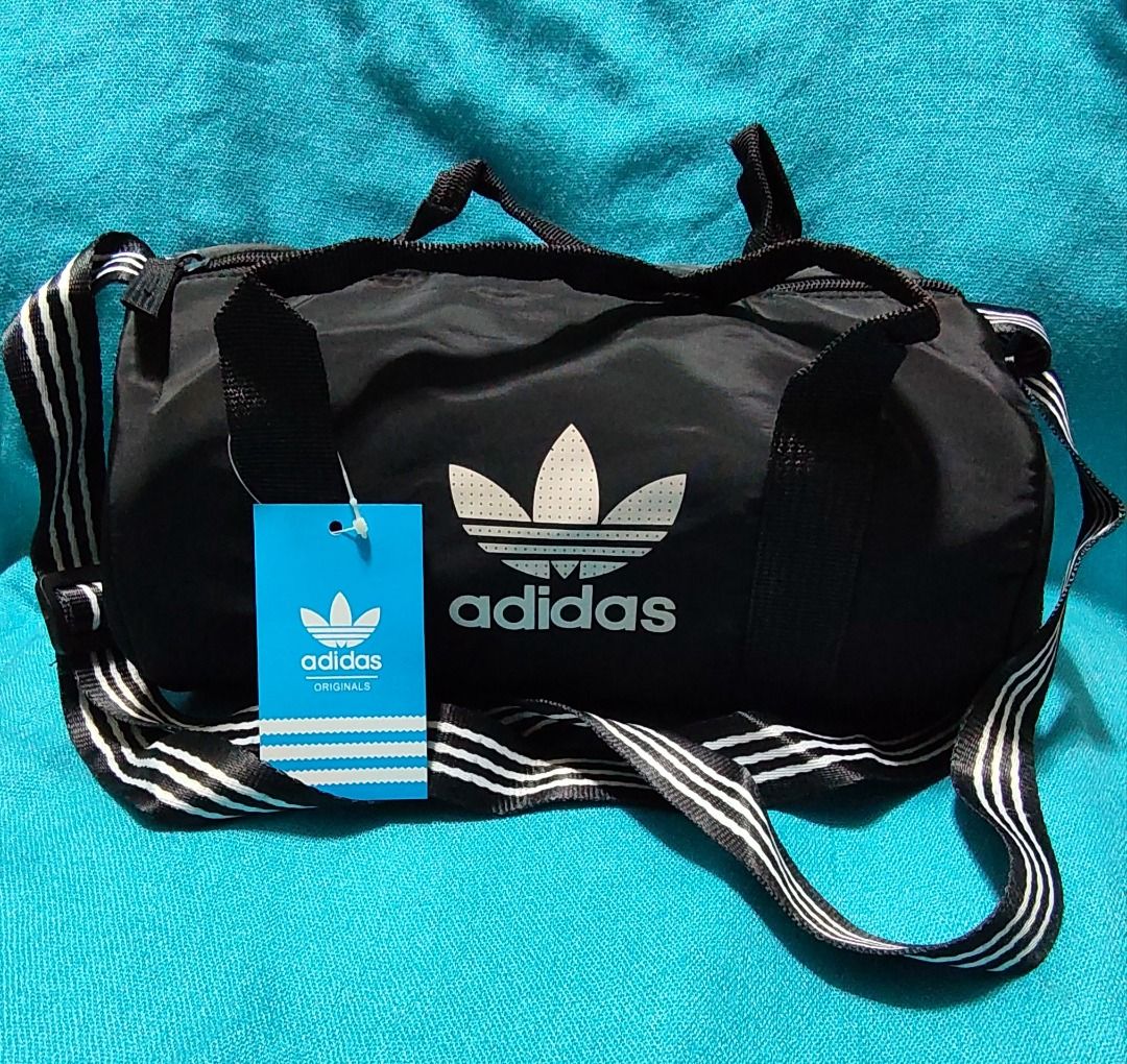 Adidas Mini Duffel Bag - Blue, Black, Navy (Category: Sling Bags) located in Caloocan City. Submitted by jpmshoppe (Listing ID 1461675020, Image 2). Description: - Adidas mini duffel bags - Perfect for gym sessions or short getaways - Iconic Adidas trefoil logo - Adjustable shoulder strap for comfort - Available colors: Blue, Black, Navy.
