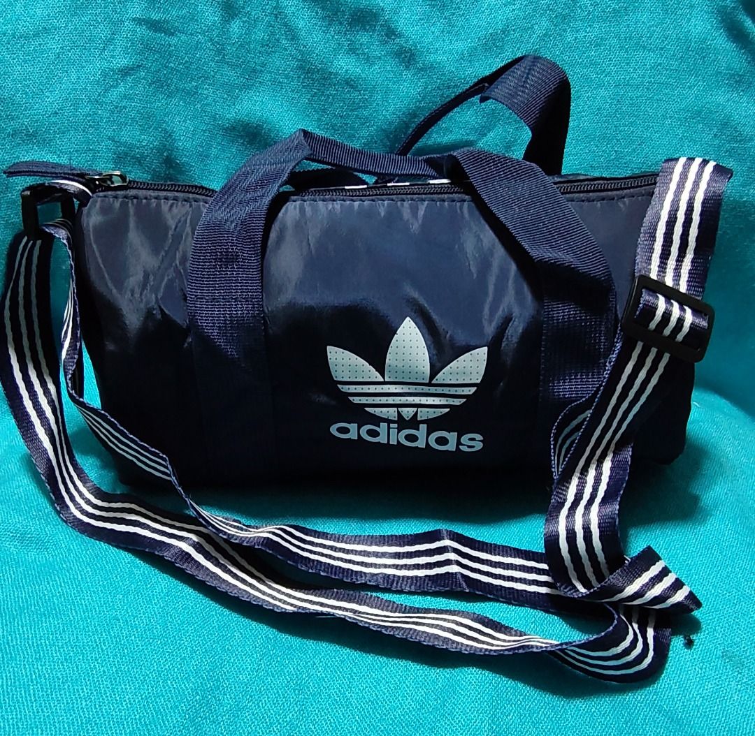 Adidas Mini Duffel Bag - Blue, Black, Navy (Category: Sling Bags) located in Caloocan City. Submitted by jpmshoppe (Listing ID 1461675020, Image 3). Description: - Adidas mini duffel bags - Perfect for gym sessions or short getaways - Iconic Adidas trefoil logo - Adjustable shoulder strap for comfort - Available colors: Blue, Black, Navy.