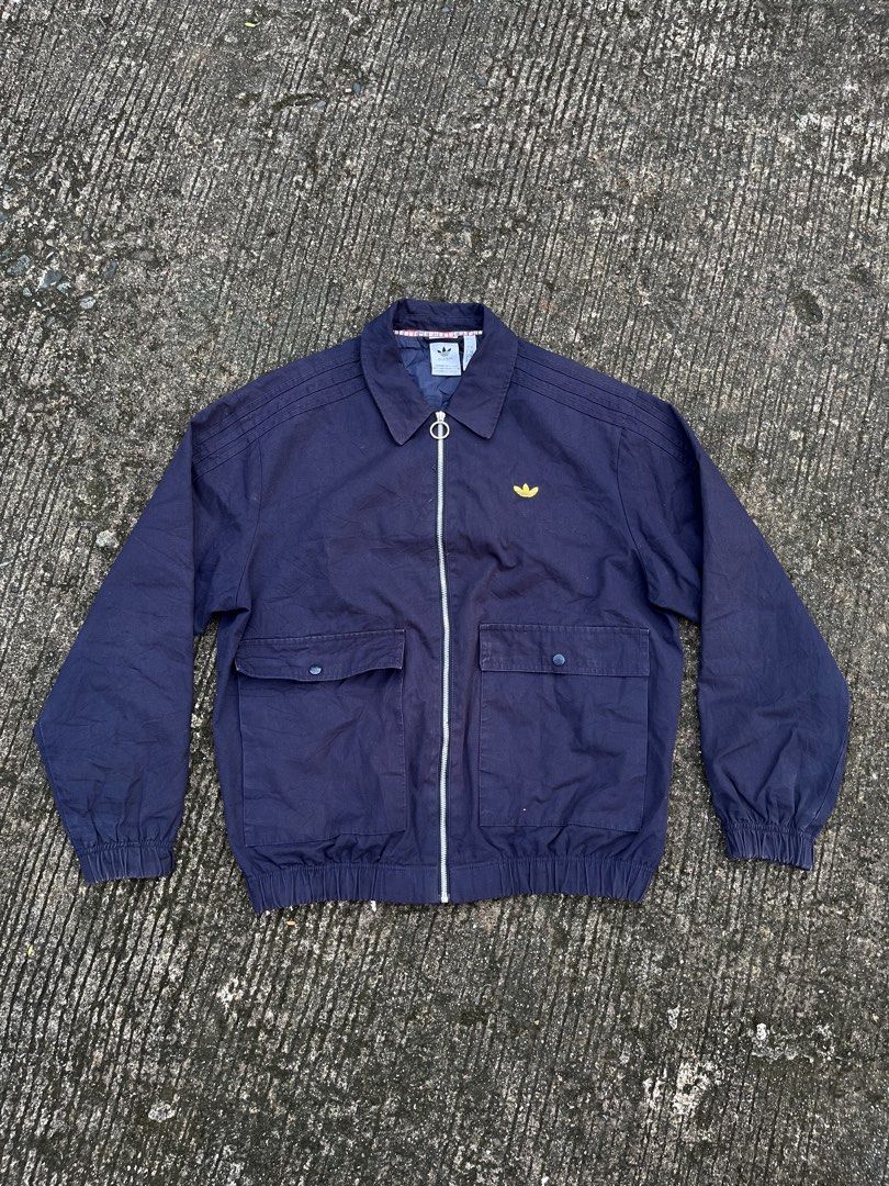 Adidas Navy Blue Track Jacket with Yellow Logo (Category: Coats, Jackets and Outerwear) located in Manila. Submitted by ok.je3m (Listing ID 1461751853, Image 1). Description: NO ISSUE W - 25 L - 27 - Classic navy blue Adidas track jacket - Iconic yellow trefoil logo on chest - Two front pockets with button closures .