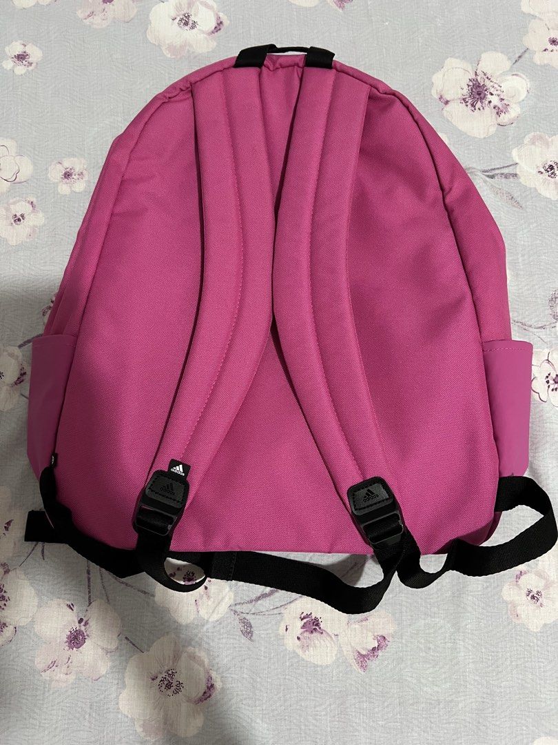 Adidas Pink Backpack (Category: Backpacks) located in Caloocan City. Submitted by allotherthings26 (Listing ID 1461637190, Image 2). Description: - Classic pink Adidas backpack - Features a front pocket for quick access - Spacious main compartment for all your essentials - Convenient side pockets for water bottles or small items - Adjustable shoulder straps for a comfortable fit - Ideal for school, work, or everyday adventures.