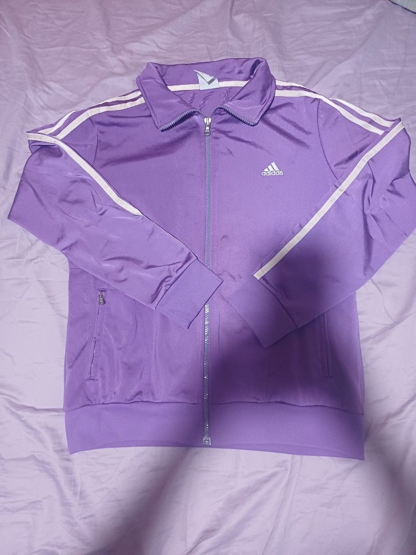 Vintage Adidas Purple Track Jacket (Category: Coats, Jackets and Outerwear) located in San Juan City. Submitted by marie_d_r (Listing ID 1461563727, Image 2). Description: - Purple Adidas track jacket - Classic white stripes on sleeves - Zip-up front with pockets - Size: Womens Large (L) - Ideal for casual wear or sports activities.