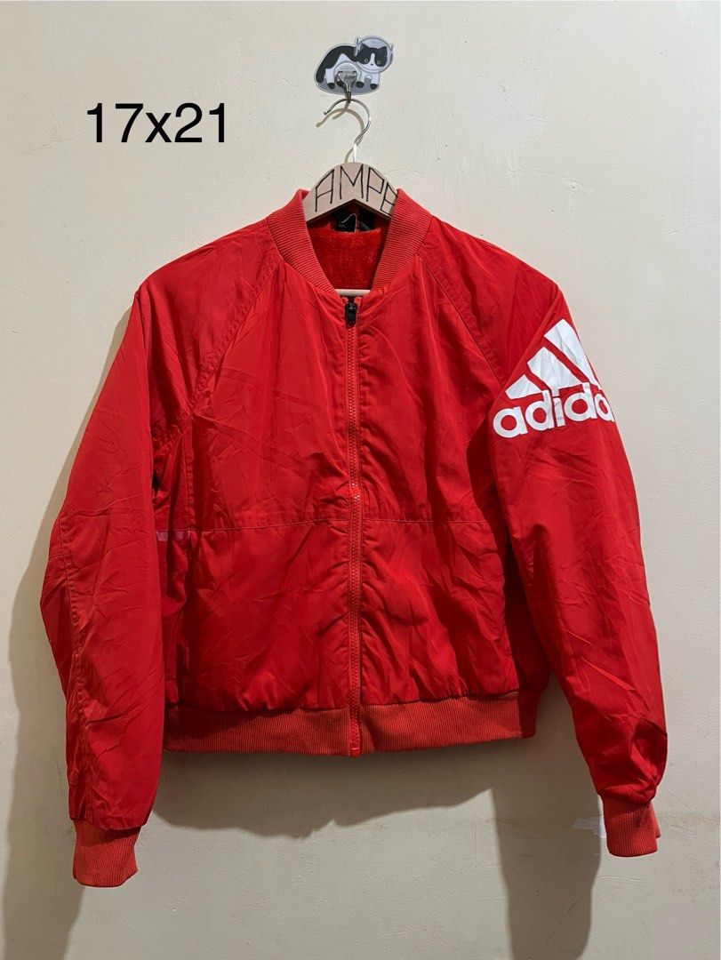 Adidas Red Bomber Jacket with Logo (Category: Coats, Jackets and Outerwear) located in Manila. Submitted by juspheroca82034 (Listing ID 1461684950, Image 1). Description: - Classic red Adidas bomber jacket - Features iconic Adidas logo on sleeve - Full zipper closure - Ribbed collar, cuffs, and hem for a snug fit - Cozy and warm interior lining - Ideal for everyday casual style -for kids 8-10 yrs old.