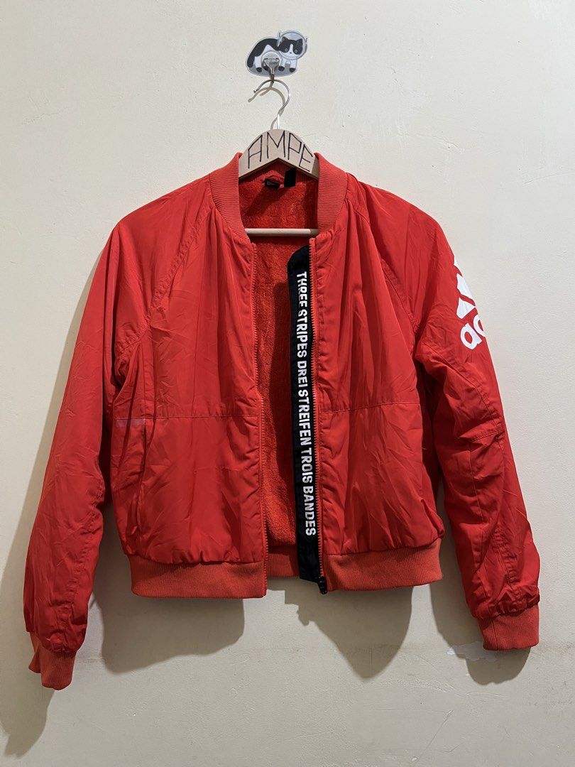 Adidas Red Bomber Jacket with Logo (Category: Coats, Jackets and Outerwear) located in Manila. Submitted by juspheroca82034 (Listing ID 1461684950, Image 3). Description: - Classic red Adidas bomber jacket - Features iconic Adidas logo on sleeve - Full zipper closure - Ribbed collar, cuffs, and hem for a snug fit - Cozy and warm interior lining - Ideal for everyday casual style -for kids 8-10 yrs old.