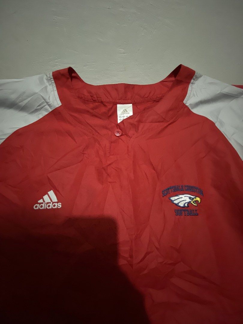 Adidas Softball Pullover Red Grey Southwestern Christian (Category: Coats, Jackets and Outerwear) located in Makati City. Submitted by dymon_08 (Listing ID 1461752158, Image 2). Description: - Adidas short sleeve pullover - Red body with grey sleeves - Features Southwestern Christian Softball logo on chest - Button closure at the neck - Adjustable drawstring at the hem - Ideal for sports activities or everyday casual wear.