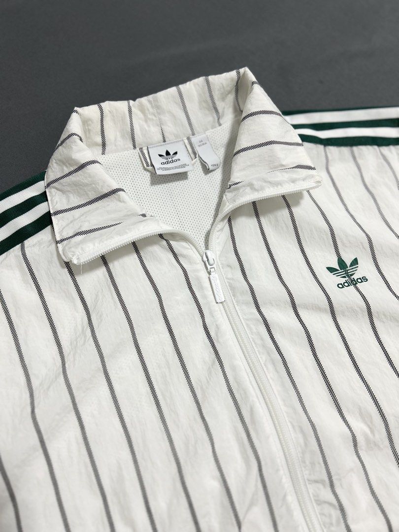 Adidas Windbreaker (Category: Coats, Jackets and Outerwear) located in Cavite. Submitted by gnthrift (Listing ID 1461575836, Image 2). Description: Adidas Stripes Windbreaker Size: M best fit Dimes: 20x21.5 Color rate: 9.8/10 Complete tags (white tag) Good as new condition. Ganda neto!! Rare finds 🙌🏻 Mine 750 + SF Location: Indang, Cavite MOP: Gcash Courier: J&T Express .