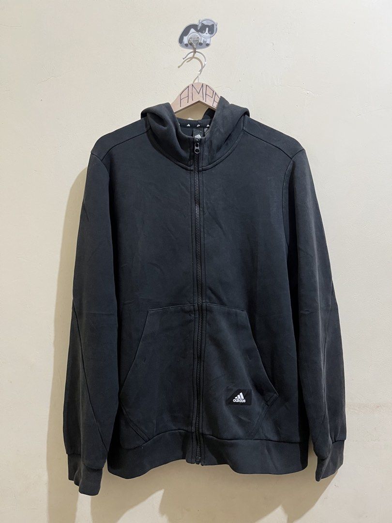Adidas Zip-Up Hoodie (Category: Coats, Jackets and Outerwear) located in Manila. Submitted by juspheroca82034 (Listing ID 1461685627, Image 2). Description: - Black Adidas zip-up hoodie - Front zip closure - Two front pockets - Standard hoodie fabric feel - Measurements: 22" pit to pit, 27" length - Perfect for casual everyday wear.