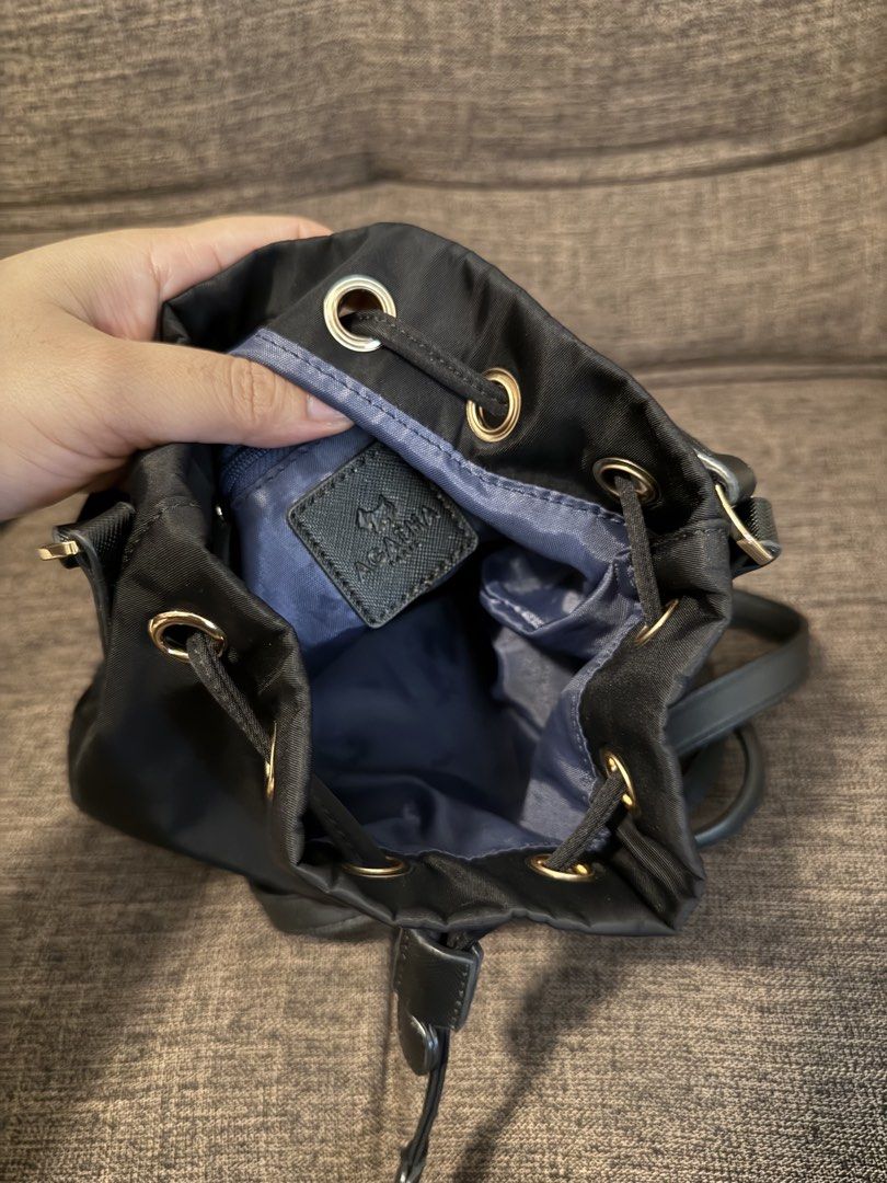 AGATHA Black Nylon Drawstring Bucket Bag with Crossbody Strap (Category: Cross-body Bags) located in Taguig. Submitted by preloved_bycarla (Listing ID 1461658590, Image 2). Description: Detachable generic crossbody strap included (old one was too thin and flimsy so I changed it) Good used condition, no flaws. Rfs: decluttering.