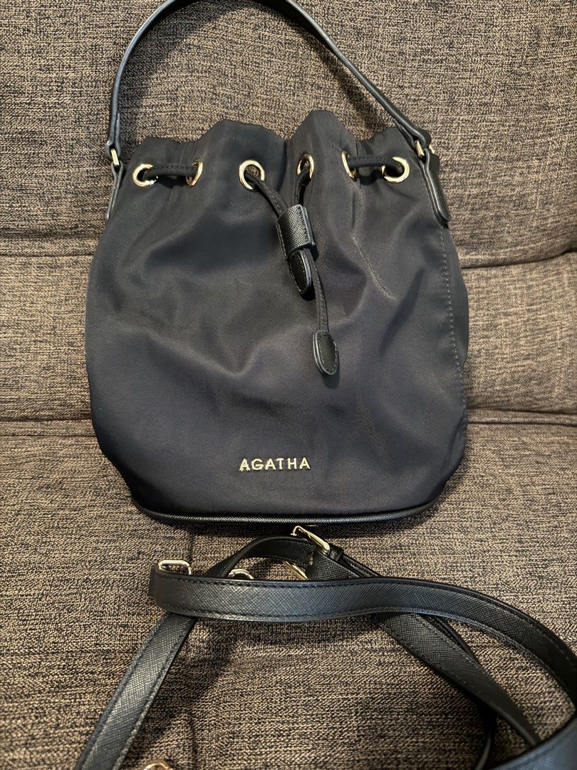 AGATHA Black Nylon Drawstring Bucket Bag with Crossbody Strap (Category: Cross-body Bags) located in Taguig. Submitted by preloved_bycarla (Listing ID 1461658590, Image 1). Description: Detachable generic crossbody strap included (old one was too thin and flimsy so I changed it) Good used condition, no flaws. Rfs: decluttering.