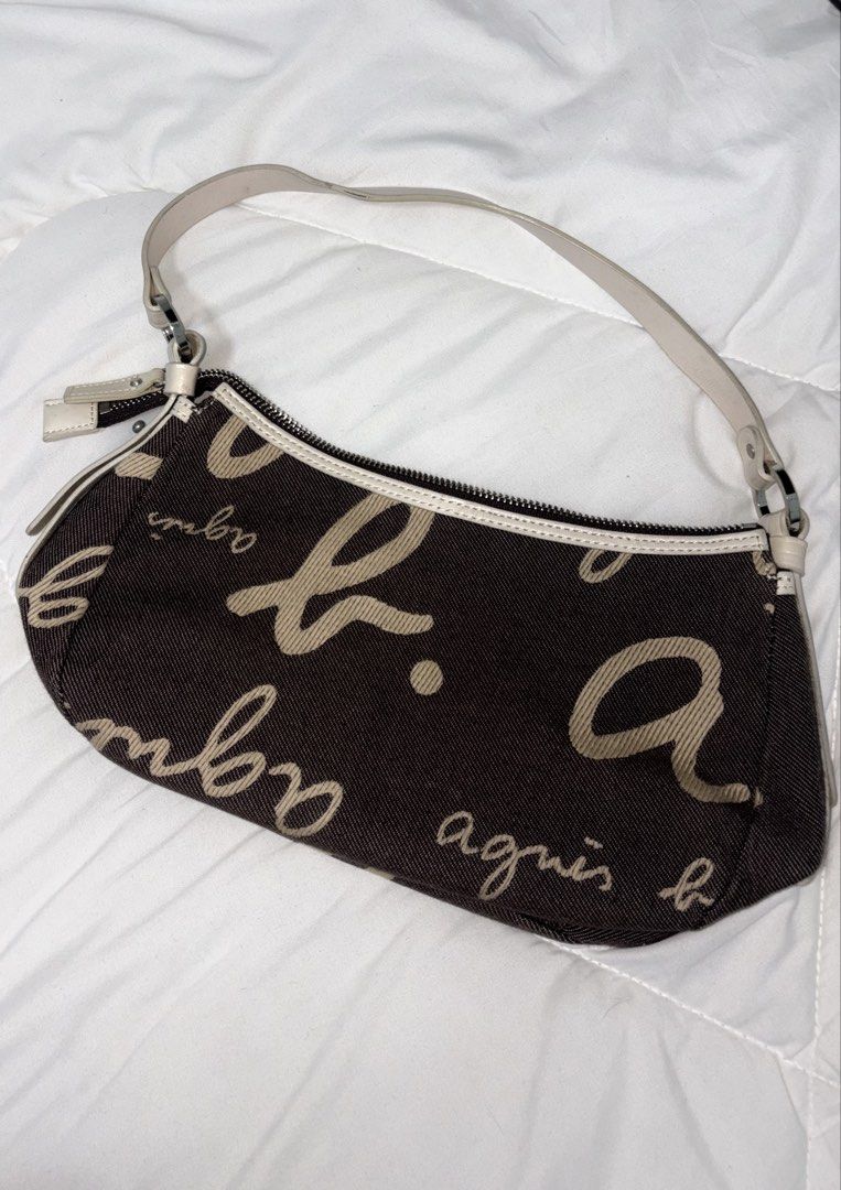 agnès b. VOYAGE Shoulder Bag (Category: Shoulder Bags) located in Manila. Submitted by weararchive.mnl (Listing ID 1461746804, Image 2). Description: FIXED PRICE Preloved but in good condition 🤎 • Brown/cream monogram design • Zipper closure • Shoulder strap • Perfect for everyday use.