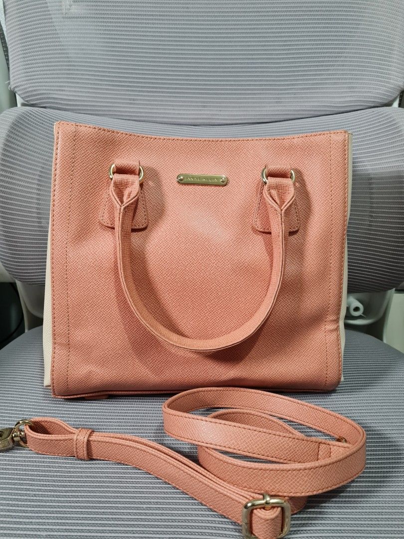 AK Cross Body Bag (Category: Cross-body Bags) located in Quezon City. Submitted by missmaui (Listing ID 1461780904, Image 1). Description: This is an Anne Klein Saffiano Faux Leather Satchel / Tote in a coral/peach and cream color combination. Key identifying features include: * Brand: Anne Klein (visible on the metallic hardware logo plaque near the top center). * Material: Saffiano textured synthetic/faux leather. * Design: Structured satchel/t