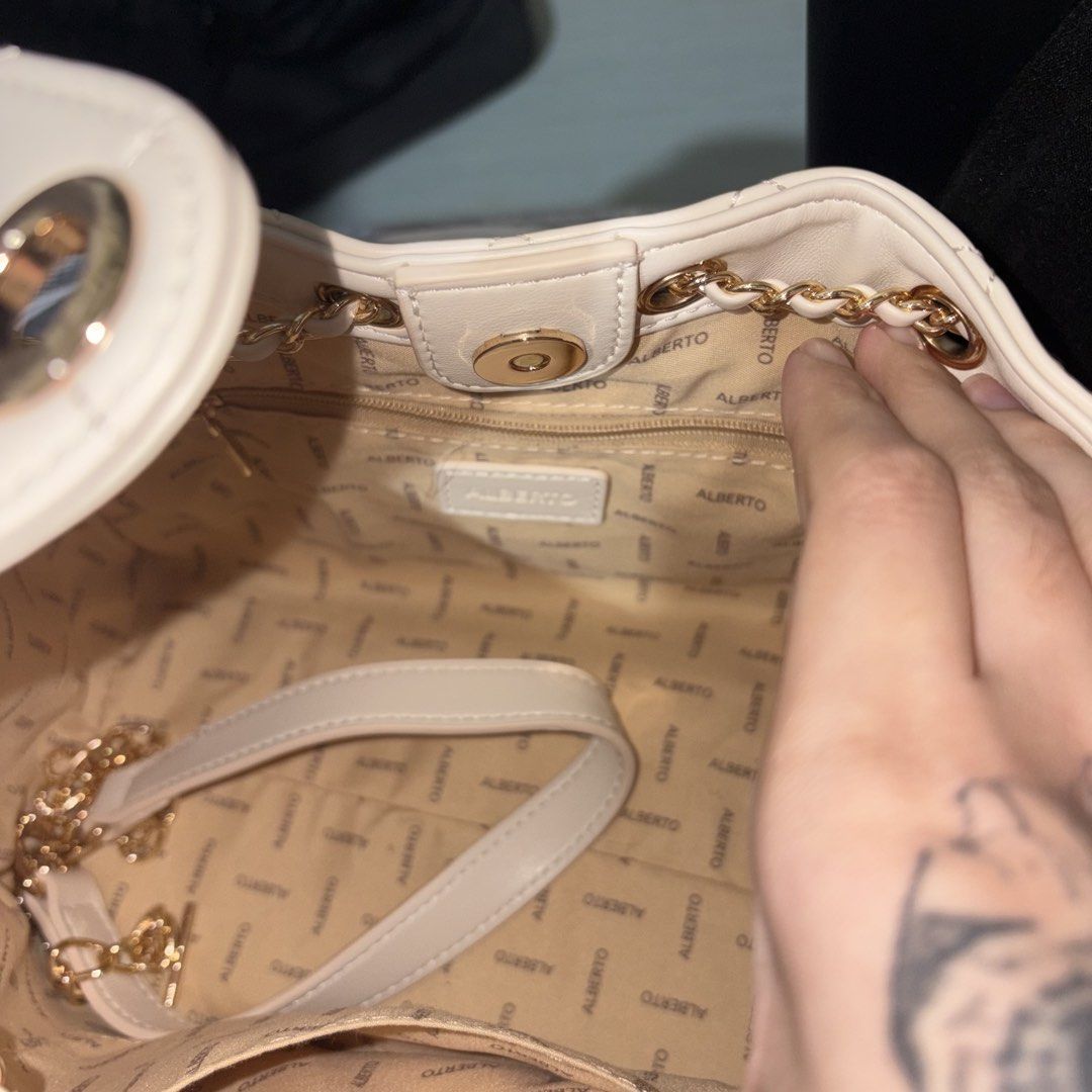 ALBERTO Quilted Chain Shoulder Bag Cream (Category: Shoulder Bags) located in Iloilo. Submitted by nana_osaki07071999 (Listing ID 1461656753, Image 1). Description: - Elegant cream quilted handbag - Stylish gold chain details - Convenient front flap pocket - Spacious main compartment - Interior lining with all-over ALBERTO logo print - Secure magnetic snap closure on front flap - Easy drawstring closure at the top - Luxurious gold hardware throug