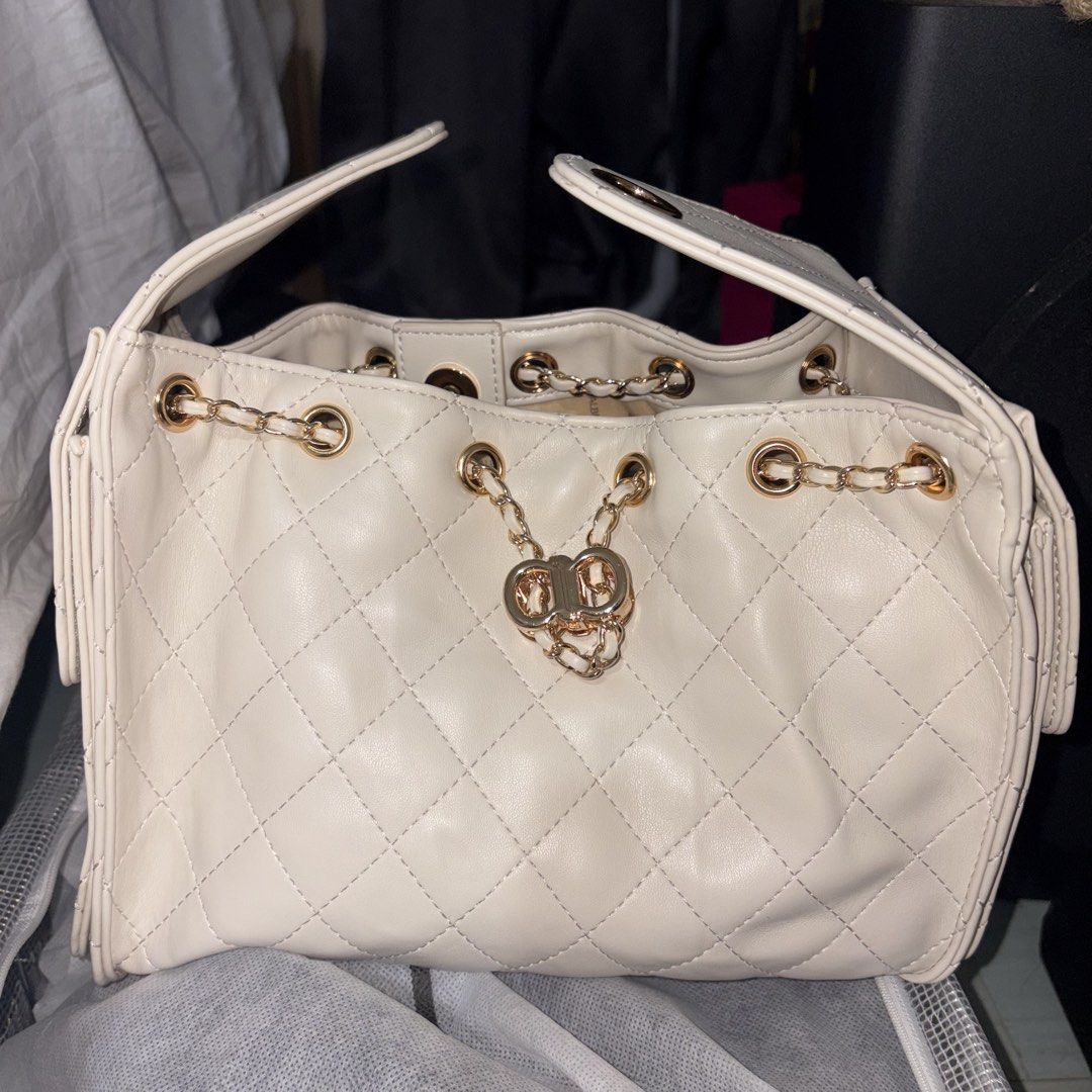 ALBERTO Quilted Chain Shoulder Bag Cream (Category: Shoulder Bags) located in Iloilo. Submitted by nana_osaki07071999 (Listing ID 1461656753, Image 3). Description: - Elegant cream quilted handbag - Stylish gold chain details - Convenient front flap pocket - Spacious main compartment - Interior lining with all-over ALBERTO logo print - Secure magnetic snap closure on front flap - Easy drawstring closure at the top - Luxurious gold hardware throug