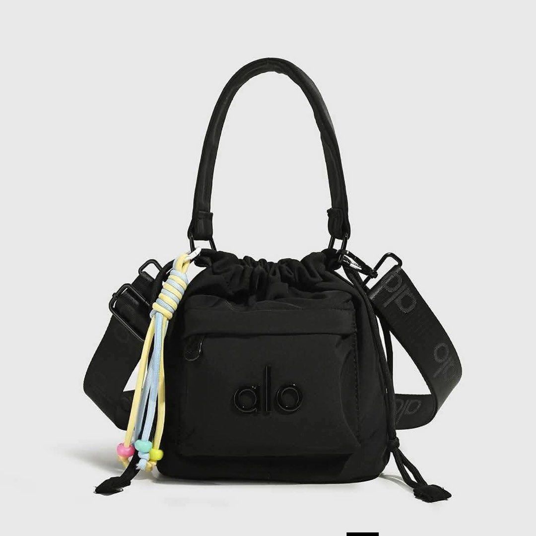 Alo Yoga Bucket Bag - Multiple Colors Available (Category: Beach Bags) located in Manila. Submitted by mellnavarro_45618 (Listing ID 1461693276, Image 1). Description: - Cute bucket bag from Alo Yoga - Drawstring closure - Front pocket - Top handle - Crossbody strap included - Fun beaded tassel detail - Ideal for everyday use or gym sessions.