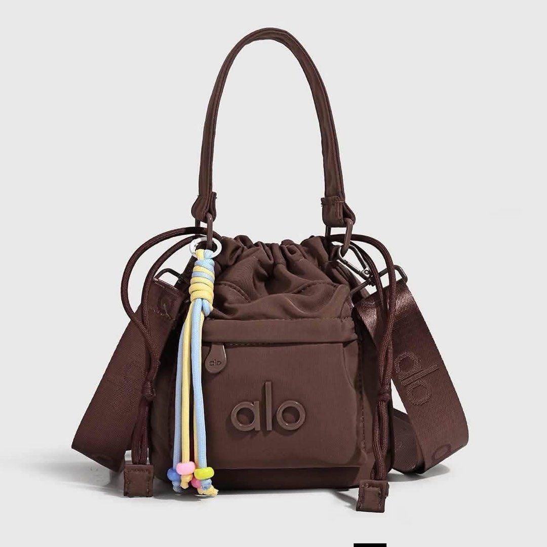 Alo Yoga Bucket Bag - Multiple Colors Available (Category: Beach Bags) located in Manila. Submitted by mellnavarro_45618 (Listing ID 1461693276, Image 3). Description: - Cute bucket bag from Alo Yoga - Drawstring closure - Front pocket - Top handle - Crossbody strap included - Fun beaded tassel detail - Ideal for everyday use or gym sessions.