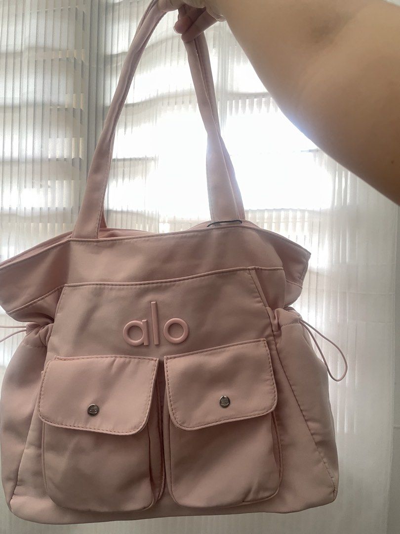 ALO Yoga Pink Tote Bag (Category: Tote Bags) located in Manila. Submitted by liyahnauh (Listing ID 1461615909, Image 2). Description: - Cute pink tote bag from ALO Yoga - Two front pockets with snap closures - Drawstring sides for adjustable width - Spacious interior - Ideal for gym or everyday use.