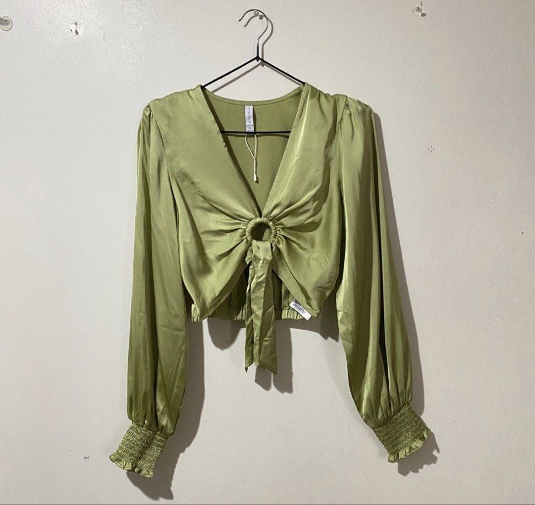 Amisu Apple Green Silk Puff Longsleeve (Category: Longsleeves) located in Binan City. Submitted by mypreloved_haul (Listing ID 1461689690, Image 1). Description: The selected region features the Amisu Apple Green Satin Tie-Front Crop Longsleeve blouse. This piece is crafted from a smooth, satin-finish polyester fabric in a vibrant apple green colorway. It features a deep V-neckline pulled together by a central ring detail, which transitions into 