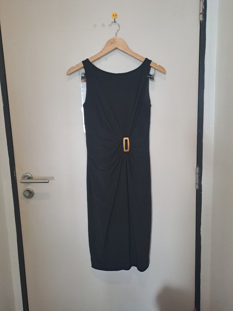 Anne Klein black dress (Category: Dresses) located in Manila. Submitted by joanbalde39643 (Listing ID 1461585239, Image 1). Description: This chic black sleeveless sheath dress features an elegant, classic silhouette with center ruching that gathers gracefully into a gold-tone rectangular buckle at the waist. The image shows the inner lining, tags, and neckline area of a black Anne Klein dress..
