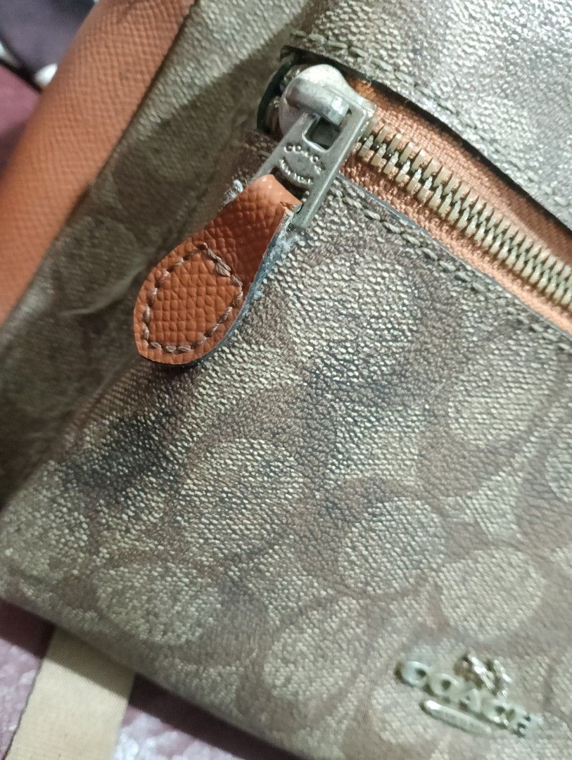 Authentic Coach Charley Backpack 35087H Signature Canvas - Preloved (Category: Luxury Bags & Wallets) located in Manila. Submitted by majimesan (Listing ID 1461712355, Image 2). Description: For sale: Authentic Coach Charley Backpack Details: - Style: 35087H - Material: Signature Coated Canvas + Crossgrain Leather - Color: Brown / Tan (Khaki Saddle) - Size: Medium (fits laptop 13", A4) - Hardware: Silver, with COACH engraved zippers Condition: Us